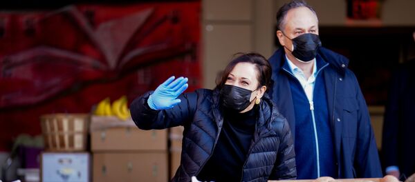 U.S. Vice President-elect Kamala Harris waves near her husband Doug Emhoff as they volunteer at Martha's Table on Martin Luther King Day in Washington - Sputnik Србија