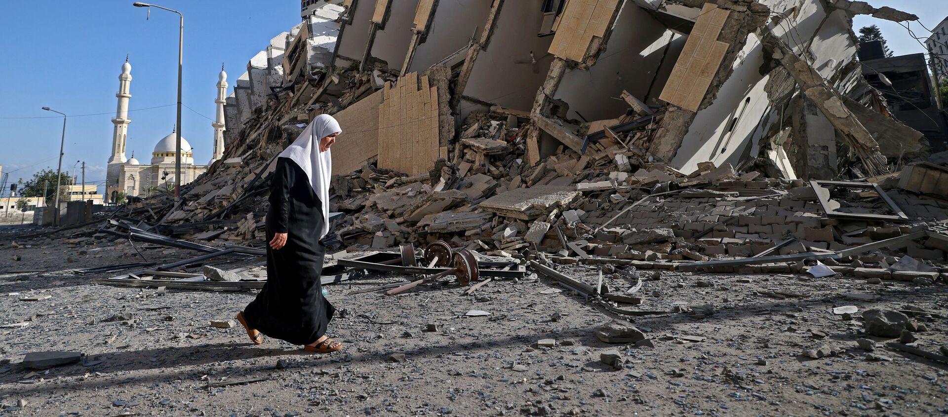 Палестинка пролази поред рушевина зграде - Sputnik Србија, 1920, 12.05.2021
