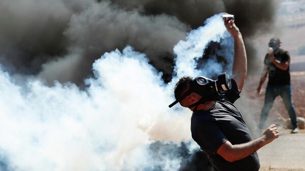 Палестински демонстрант враћа сузавац који су испалили израелски војници - Sputnik Србија