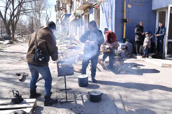 Становници кувају храну на једној од улица Маријупоља. - Sputnik Србија