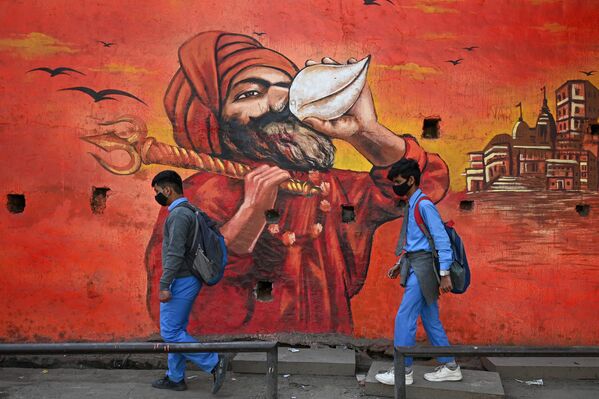 Đaci u Nju Delhiju na putu do škole prolaze pored murala. - Sputnik Srbija