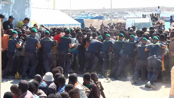 Policija sprečava migrante da sa doka dođu do unutrašnjosti ostrva Lampeduza u Italiji - Sputnik Srbija