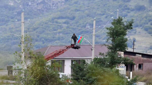 Радник поставља заставу Азербејџана на једно од насеља у Нагорно Карабаху - Sputnik Србија