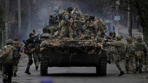 Ukrainian servicemen climb on a fighting vehicle outside Kyiv, Ukraine, Saturday, April 2, 2022 - Sputnik Србија