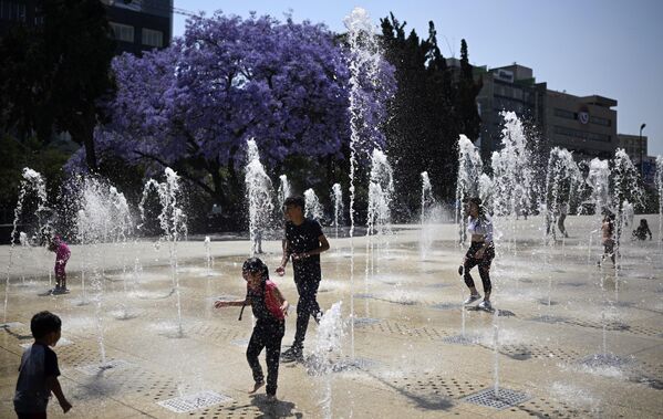 Људи се расхлађују у фонтани „Монументо а ла Револусион“ у Мексико Ситију 15. марта 2024. године, пошто су у граду забележене рекордно високе температуре преко 30 степени Целзијуса. - Sputnik Србија