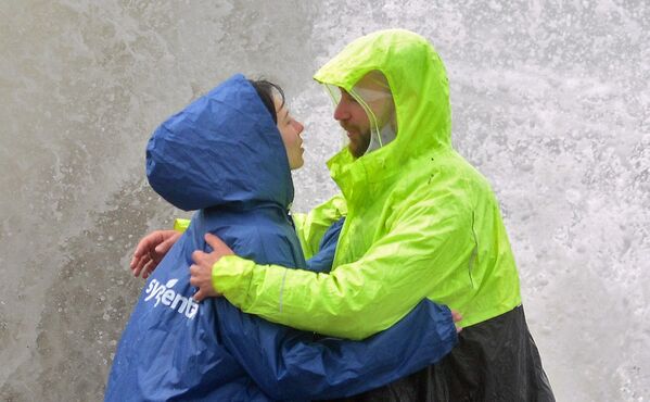 Људи се грле усред олујних таласа на Црном мору у Сочију. - Sputnik Србија