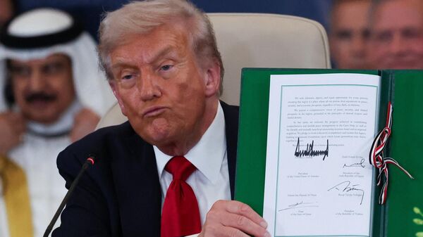 Donald Tramp pokazuje potpisani mirovni sporazum između Izraela i Hamasa. - Sputnik Srbija