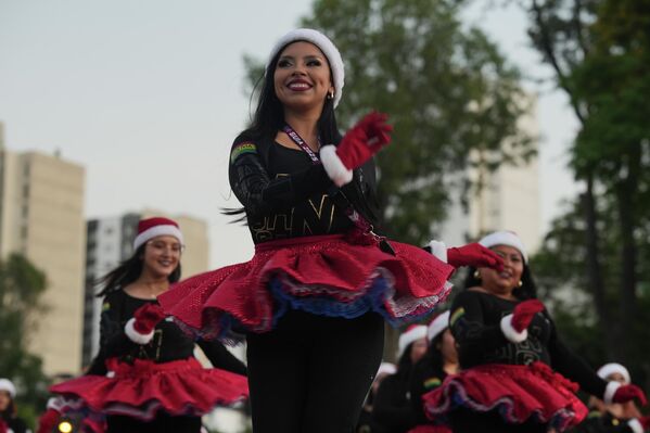 Плесачице парадирају обучени као Баба Мразице током божићног програма у општинском парку у Лими, Перу. - Sputnik Србија