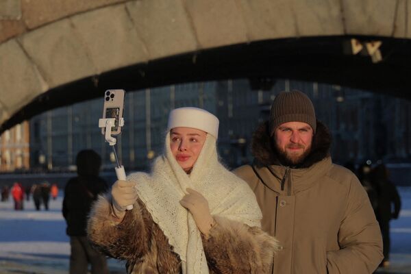 Људи шетају по залеђеној реци Фонтанки у центру Санкт Петербурга. - Sputnik Србија