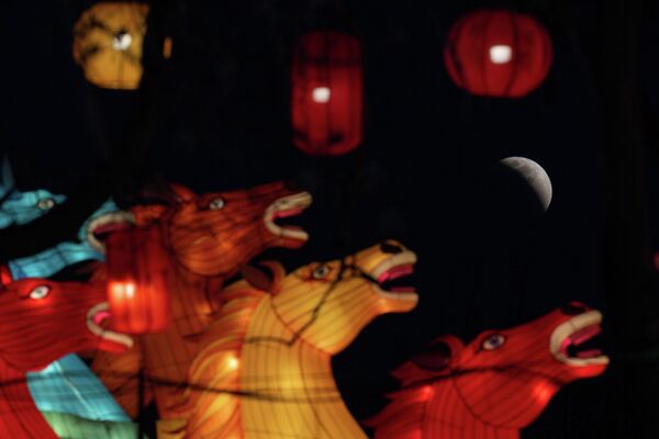 Mesec se vidi neposredno pre potpunog pomračenja, u blizini lampiona u obliku konja u Pekingu. - Sputnik Srbija