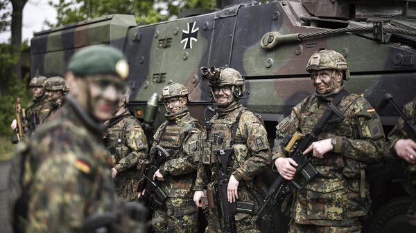 Soldiers of the German forces, Bundeswehr, stand in front of a Boxer military vehicle, a new type of armoured personnel carrier, at the Julius Leber Barracks in Berlin, Germany, Wednesday, April 24, 2024.  - Sputnik Србија