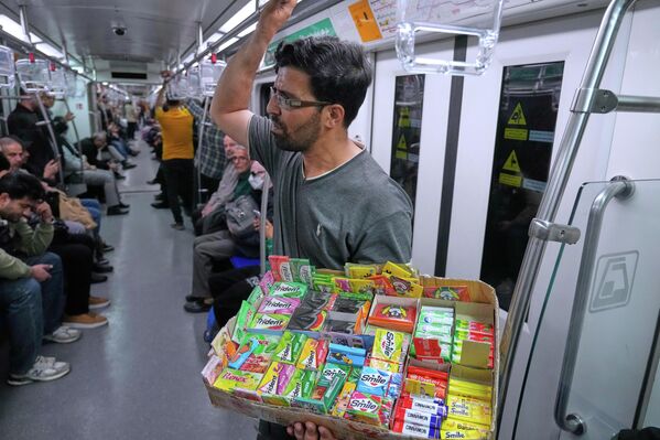 Улични продавац продаје жваке у метро возу у Техерану. - Sputnik Србија