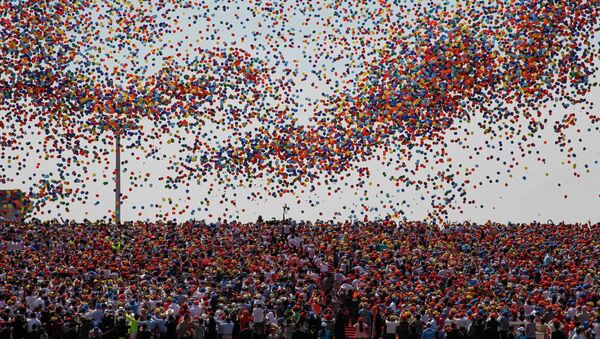Balloons are released as a crowd looks up during a military parade over Tiananmen Square in Beijing on September 3, 2015, to mark the 70th anniversary of victory over Japan and the end of World War II - Sputnik Srbija