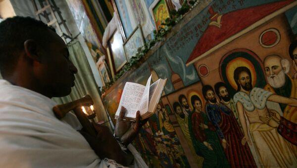 Етиопски свештеник чита молитву у Етиопској православној цркви у главном граду Адис Абеби - Sputnik Србија