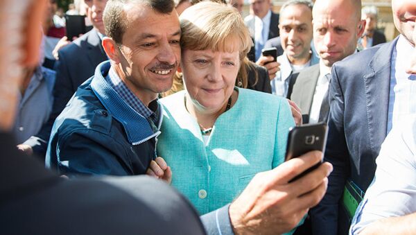 Merkelova sa izbeglicama - Sputnik Srbija