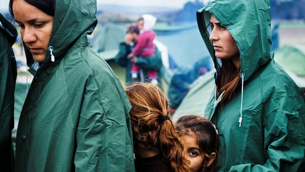 Мигранти у реду за храну у импровизованом прихватном центру на грчко-македонској граници, у близини села Идомени - Sputnik Србија