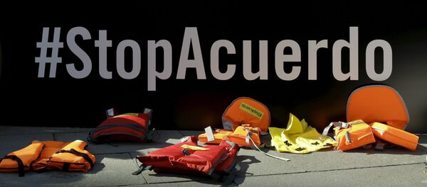 Појасеви за спасавање испред натписа Зауставите споразум током протеста против споразума Турска-ЕУ испред Министарства спољних послова у Мадриду. Појасеви за спасавање испред натписа Зауставите споразум током протеста против споразума Турска-ЕУ испред Министарства спољних послова у Мадриду. - Sputnik Србија