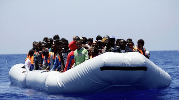 Grupa izbeglica iz Afrike snimljena u čamcu za spasavanje na Mediteranu u blizini libijske obale. - Sputnik Srbija