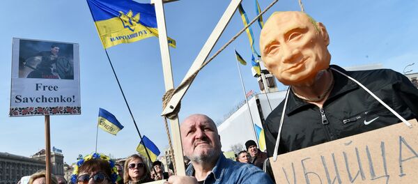 Демонстранти носе лутку са ликом Владимира Путина на вешалу и поруком „убица” Демонстранти носе лутку са ликом Владимира Путина на вешалу и поруком „убица” - Sputnik Србија