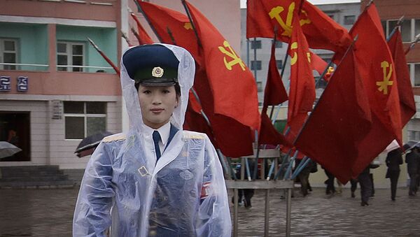 Severnokorejska saobraćajna policajka ispred zastava vladajuće Komunističke partije u Pjongjangu - Sputnik Srbija