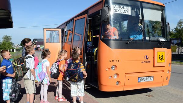 Деца стоје у реду да уђу у школски аутобус у Кулигову у Пољској. - Sputnik Србија