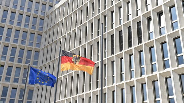 The German (R) and the European flag fly in the wind outside the new Federal Ministry of the Interior building in Berlin on April 26, 2015 - Sputnik Србија