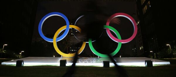 A woman walks past Olympic rings placed at the entrance of a office building ahead of the Rio 2016 Olympic Games, in Sao Paulo, Brazil, July 19, 2016. - Sputnik Србија