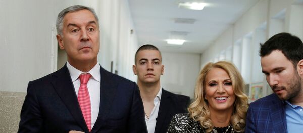 Премијер Црне Горе Мило Ђукановић након гласања са супругом и сином. Премијер Црне Горе Мило Ђукановић након гласања са супругом и сином. - Sputnik Србија