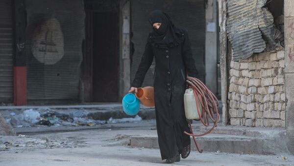 A woman walks in a residential area of Aleppo, a city divided by a front line (File) - Sputnik Srbija