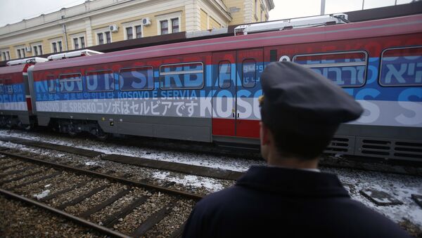 Železničar stoji pored voza koji saobraća na liniji Beograd-Kosovska Mitrovica - Sputnik Srbija
