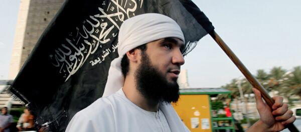 Припадник либијске терористичке групе Ансар ал-Шеријат носи заставу организације. - Sputnik Србија