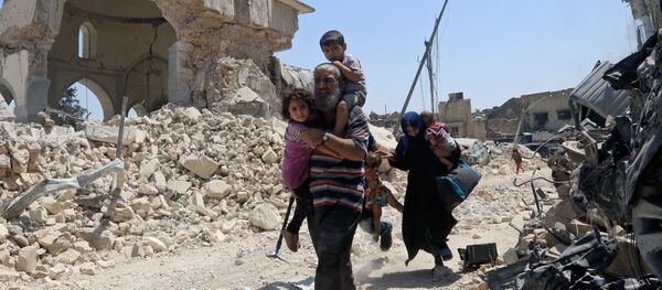 Ирачки цивили поред оштећене џамије Нури током офанзиве ирачких снага против милитаната ДАЕШ-а у Мосулу - Sputnik Србија