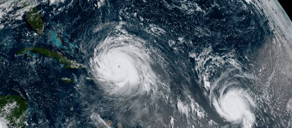 In this GOES-16 geocolor image satellite image taken Thursday, Sept. 7, 2017, the eye of Hurricane Irma, left, is just north of the island of Hispaniola, with Hurricane Jose, right, in the Atlantic Ocean - Sputnik Srbija