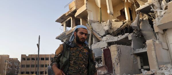 Pripadnik Sirijskih demokratskih snaga koje podržavaju SAD u porušenoj Raki - Sputnik Srbija