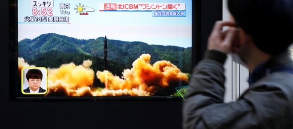 Čovek u Tokiju gleda televizijski izveštaj raketne probe Severne Koreje - Sputnik Srbija