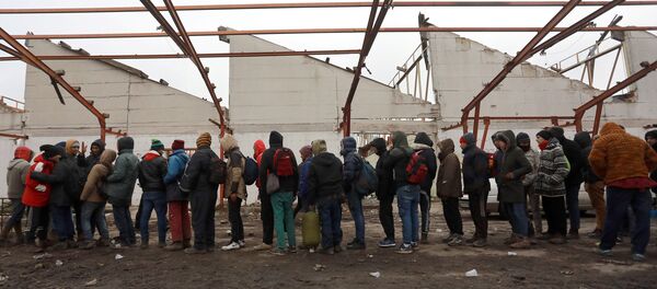 Migranti stoje u redu za hranu u napuštenoj fabrici u blizini hrvatske granice u Šidu - Sputnik Srbija