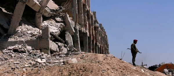 Припадник сиријских владиних снага стоји поред уништене зграде у Џобару, у Источној Гути - Sputnik Србија