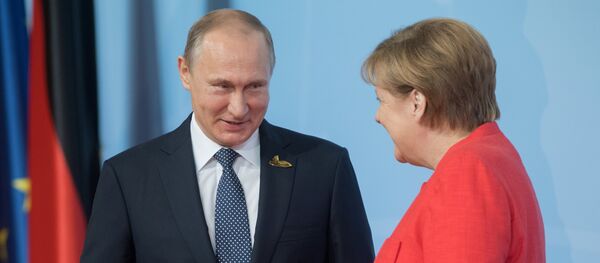 Ruski predsednik Vladimir Putin i nemačka kancelarka Angela Merkel - Sputnik Srbija