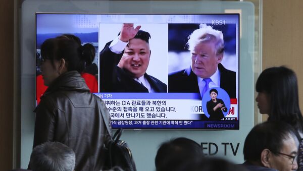 People pass by a TV screen showing file footages of U.S. President Donald Trump, right, and North Korean leader Kim Jong Un during a news program at the Seoul Railway Station in Seoul, South Korea, Monday, April 9, 2018 - Sputnik Srbija