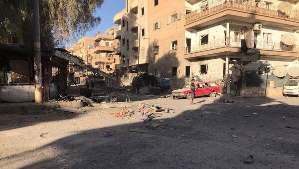 Последице ракетног напада на четврт Ел Кусур у сиријском граду Дејр ел Зор - Sputnik Србија