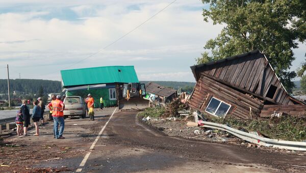 Цивили и припадници спасилачке службе поред уништених кућа након поплава у Иркутској области - Sputnik Србија