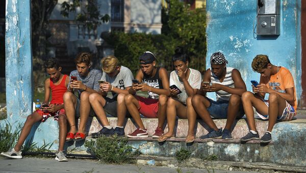 Mladi Kubanci sa mobilnim telefonima na ulicama Havane - Sputnik Srbija