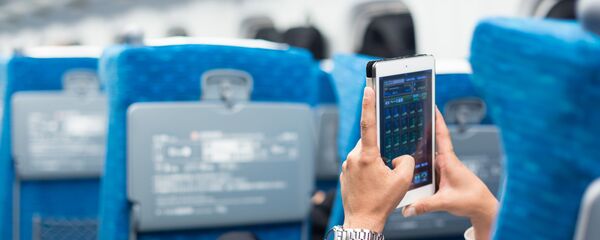 Бизнисмен користи телефон у авиону Бизнисмен користи телефон у авиону - Sputnik Србија