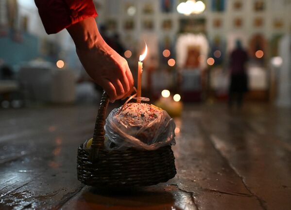 Vernica drži korpu sa uskršnjim kolačem za vreme pravoslavne uskršnje službe u crkvi u selu Jekaterininska u Omskoj oblasti - Sputnik Srbija
