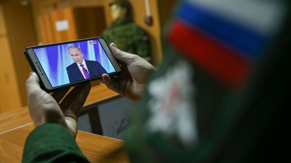 Ruski vojnik prati obraćanje predsednika Vladimira Putina - Sputnik Srbija