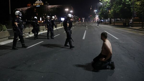 Demonstrant kleči ispred pripadnika policije na protestu ispred Skupštine Srbije u Beogradu - Sputnik Srbija