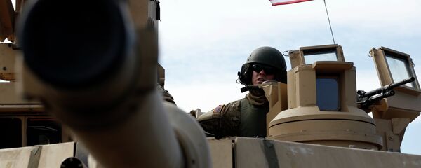 A U.S. soldier from the 2nd Battalion, 1st Brigade Combat Team, 3rd Infantry Division ride on an M1A2 Abrams battle tank during a military exercise at the Gaiziunu Training Range in Pabrade some 60km.(38 miles) north of the capital Vilnius, Lithuania A U.S. soldier from the 2nd Battalion, 1st Brigade Combat Team, 3rd Infantry Division ride on an M1A2 Abrams battle tank during a military exercise at the Gaiziunu Training Range in Pabrade some 60km.(38 miles) north of the capital Vilnius, Lithuania - Sputnik Srbija