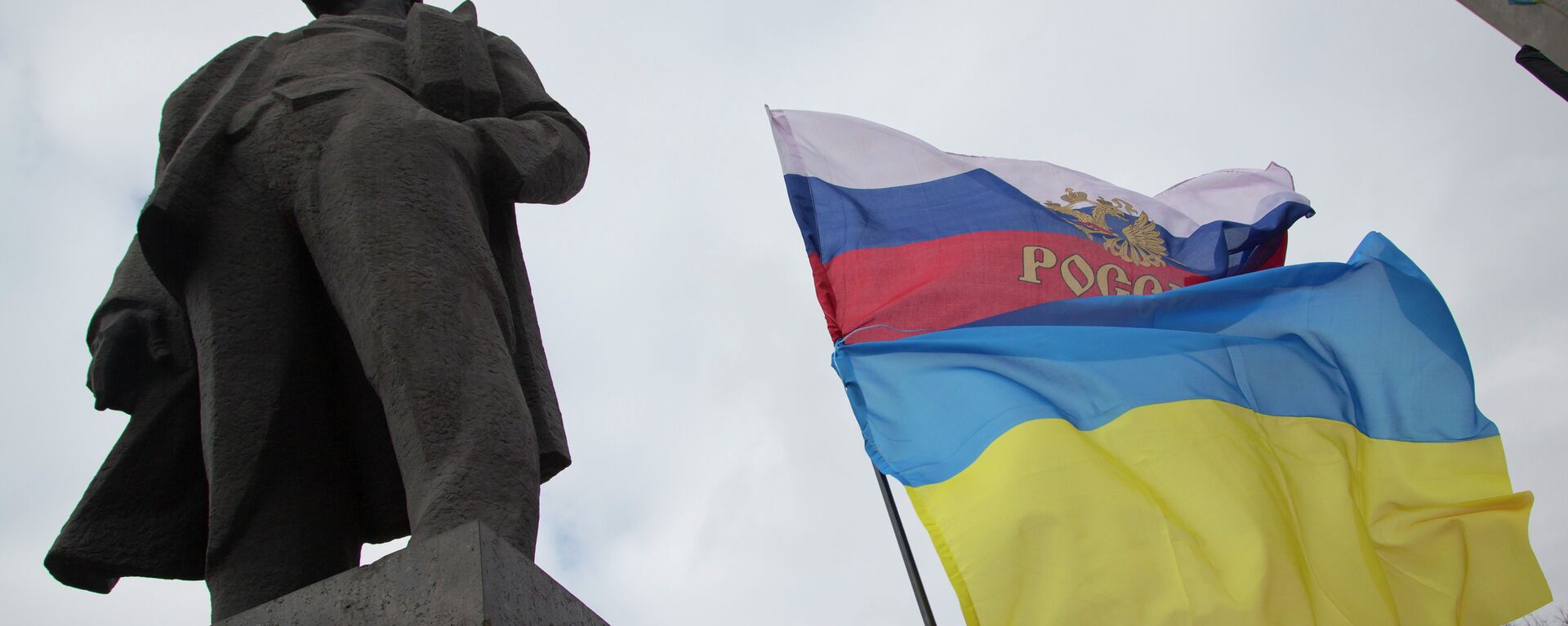 Zastave Ukrajine i Rusije pored spomenika Vladimira Iljiča Lenjina, u Donjecku, istočnoj Ukrajini - Sputnik Srbija, 1920, 24.02.2022