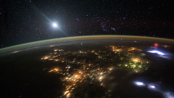 Летећи преко Централне Америке овог месеца, астронаут је направио дивну фотографију вечерњег неба изнад Земље осветљене огромним црвеним млазевима електромагнетних пражњења познатих као „Вилењак“ - Sputnik Србија