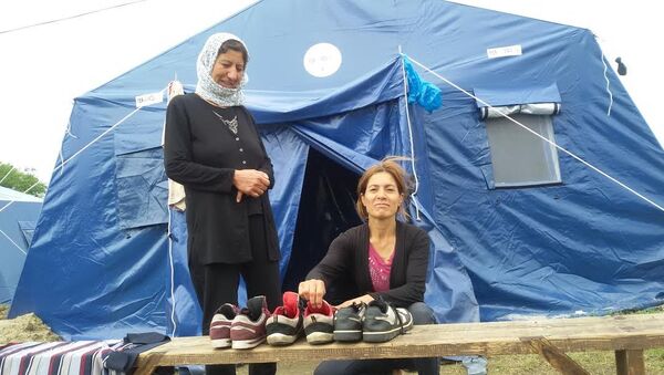 Sirijka Nadia i majka njenog muža proveravaju da li je obuća suva, od čega zavisi polazak na dalje putovanje ka severu - Sputnik Srbija